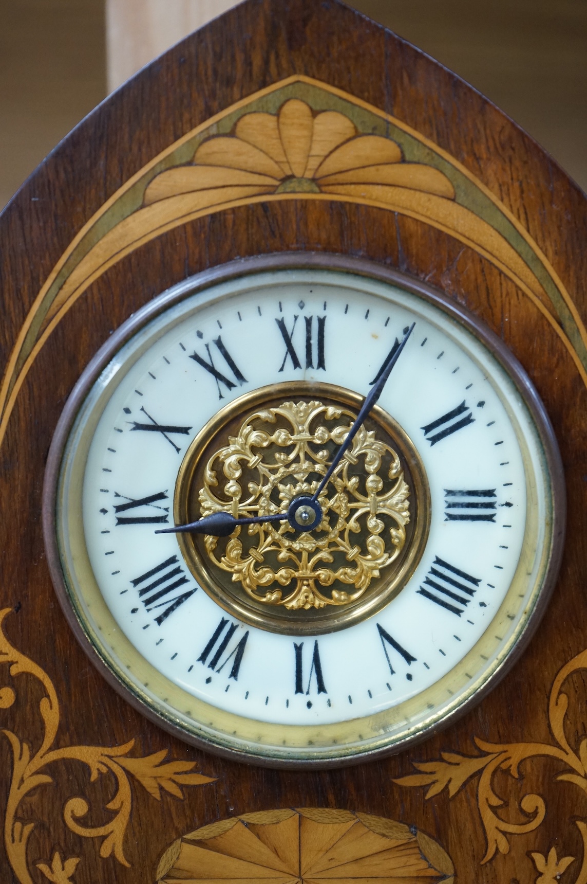 An Edwardian inlaid mahogany lancet shaped eight day mantel timepiece, with key, 23cm high